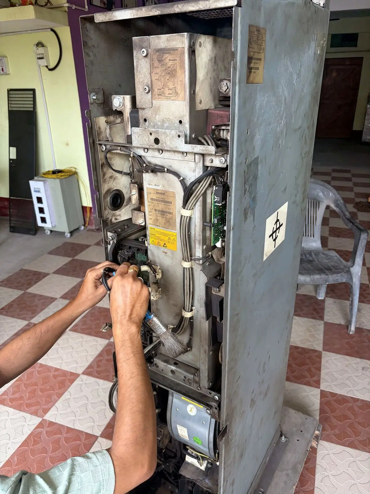 Technician working inside a cabinet-type drive